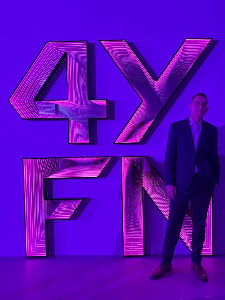 Stefan Zindovic standing next to a large 4YFN neon sign in Barcelona in March 2026