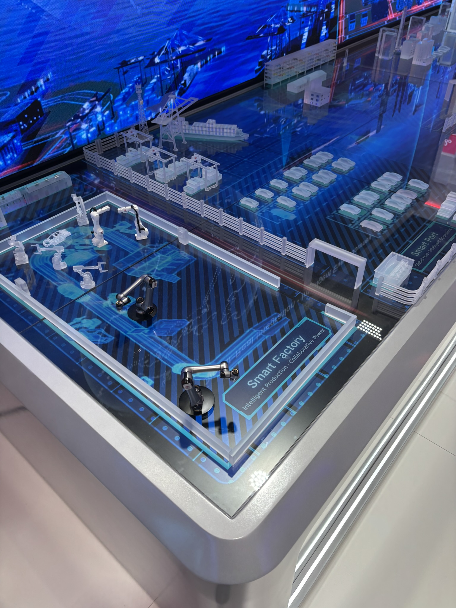 Smart factory display with robotic arms at MWC Barcelona in March 2026