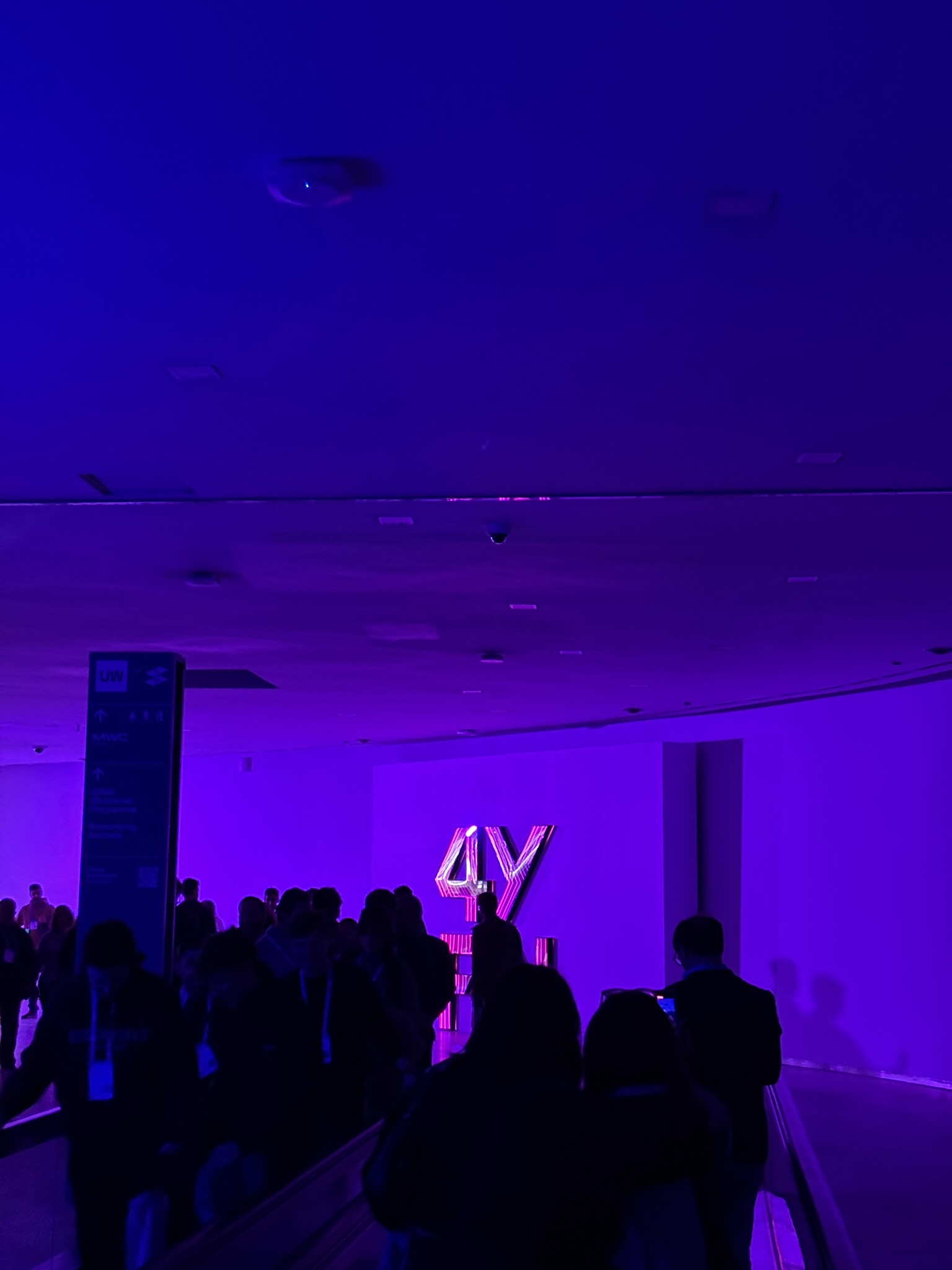 Crowd walking through a purple-lit 4YFN hall in Barcelona in March 2026