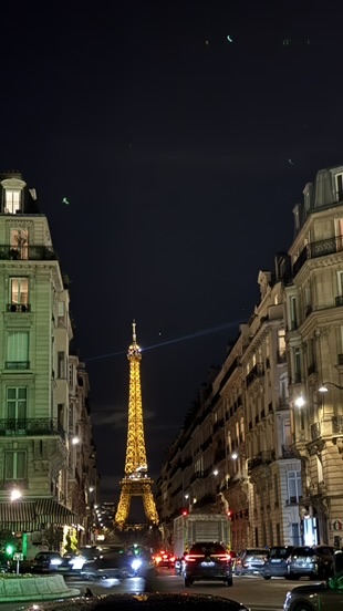 Night view of the Eiffel Tower from a Paris street on March 26, 2026